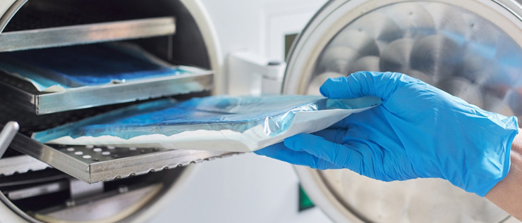 Image of a hand holding a clear bag with blue contents