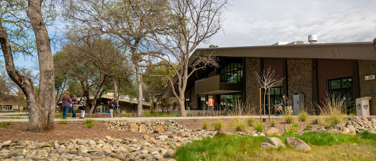 Image of people walking outside in front of a building