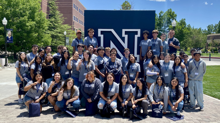 Group of students standing in front of a university. 