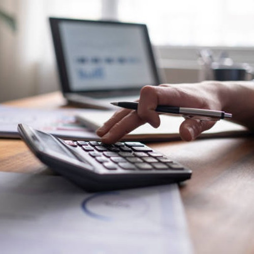 Person using calculator at desk