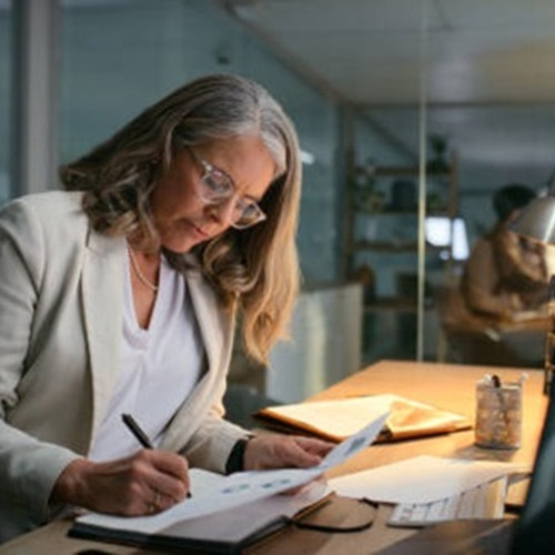 Woman at desk doing accounting items
