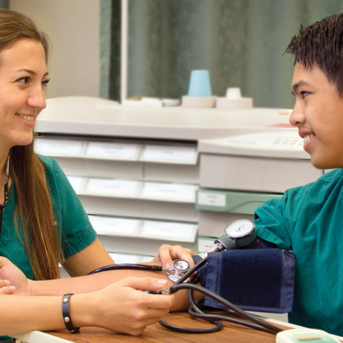 Two nursing students taking blood pressure